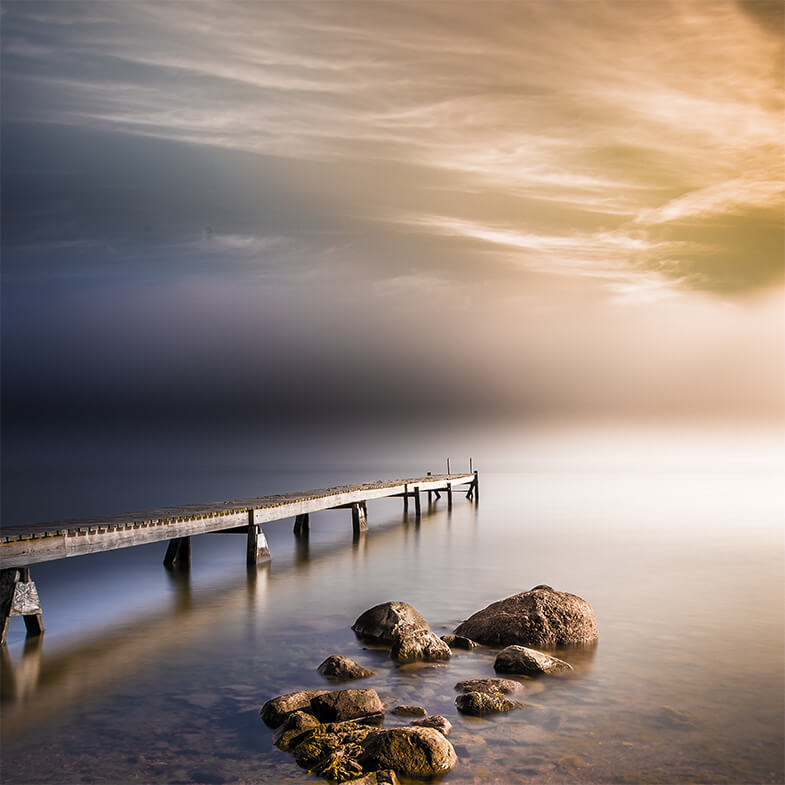 Wooden pier stretching out over a calm sea. Cover photo for MPA network design and management. Photo: Shutterstock.